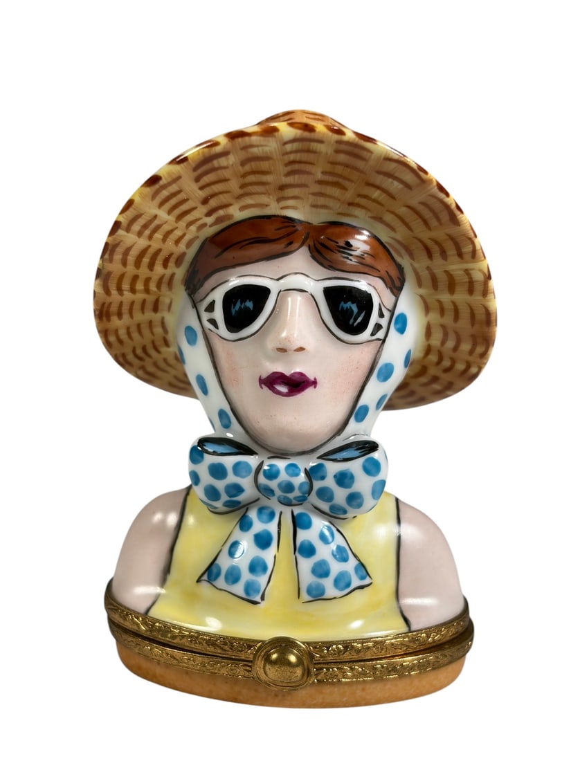 Artoria Lady Tourist Limoges Trinket Box France: French Artoria Limoges porcelain hinged trinket box modeled as the "Lady Tourist", featuring a lady wearing sunglasses, a wide-brim straw hat, and a blue polka-dot scarf. Hand painted and marked Artor
