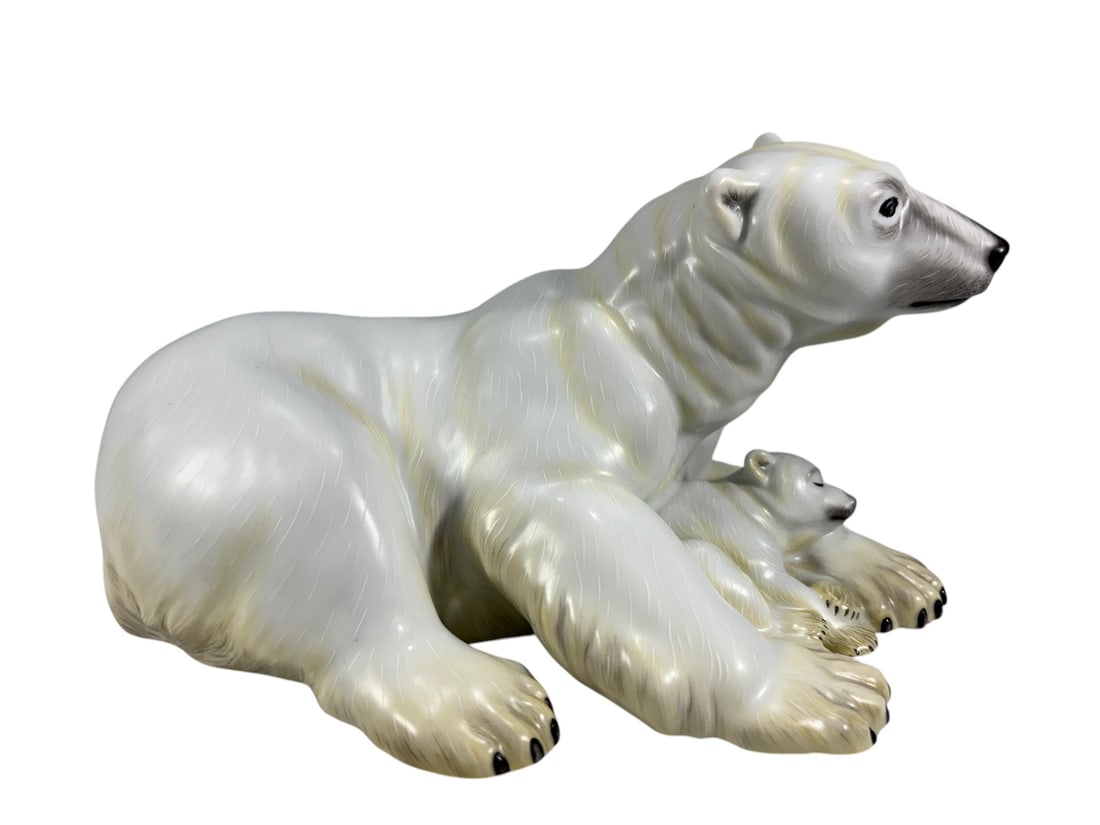 Herend Hungary Polar Bear & Cub Porcelain Figurine: Herend Hungary hand painted porcelain figural group depicting a polar bear with a sleeping cub nestled between its front paws. Finely modeled with incised fur detailing, creamy white coloration with s