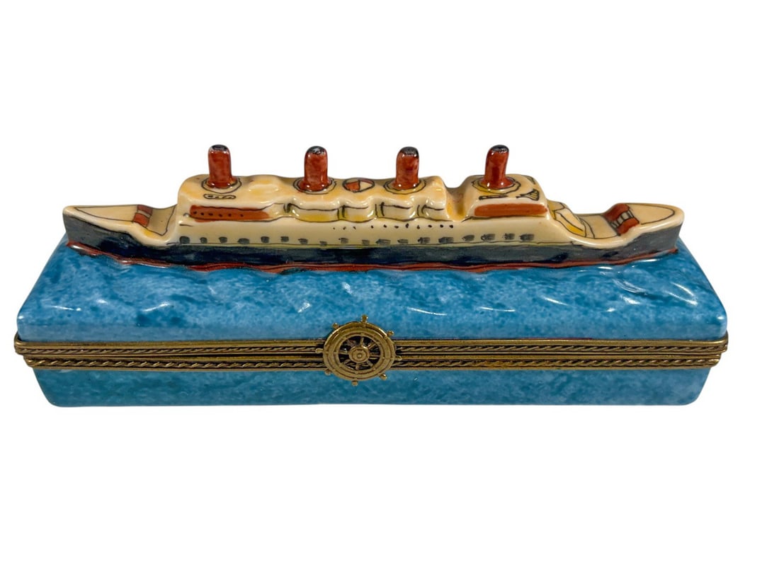 Limoges France Titanic Ship Porcelain Trinket Box: Hand painted Limoges France porcelain trinket box depicting the RMS Titanic ocean liner sailing across a textured blue sea. The ship is modeled in relief with four red and black funnels, cream superst