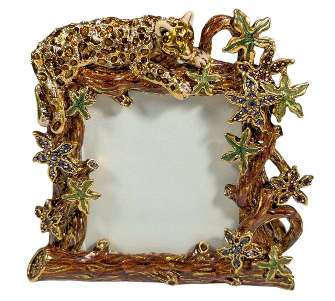 Jay Strongwater Jeweled Leopard Branch Photo Frame: Jay Strongwater, American, born 1960. Decorative photo frame featuring a dimensional reclining leopard draped across the upper branch, densely embellished with amber, brown, and clear crystals.
