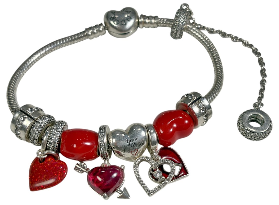 Pandora Sterling Silver Heart Charm Bracelet: Pandora sterling silver charm bracelet featuring a heart-shaped clasp and multiple red heart beads and heart-themed charms, including pave-style and dangling elements. Marked Pandora. Approximate inte