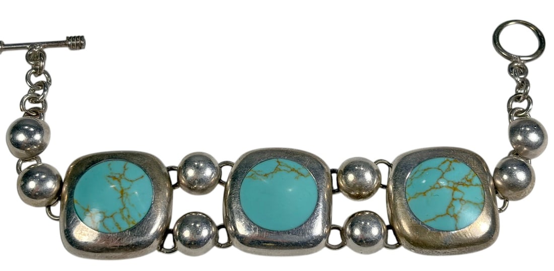 Mexico Sterling Silver Turquoise Cabochon Bracelet: Mexican sterling silver bracelet set with three large turquoise-colored cabochons in rounded square settings, separated by polished silver beads and finished with a toggle clasp. Reverse stamped MEXIC