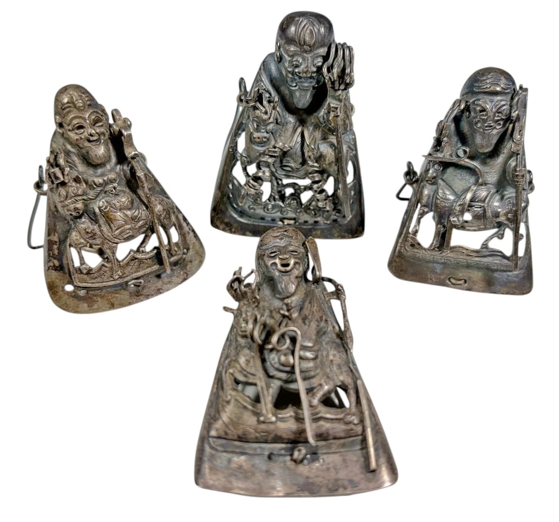 Chinese Silver Elderly Figural Ornaments 4pc LOT: Set of four Chinese silver figural ornaments, each modeled as a seated elderly male figure with detailed robes, facial features, and small attributes. Each piece is fitted with a wire support and chai