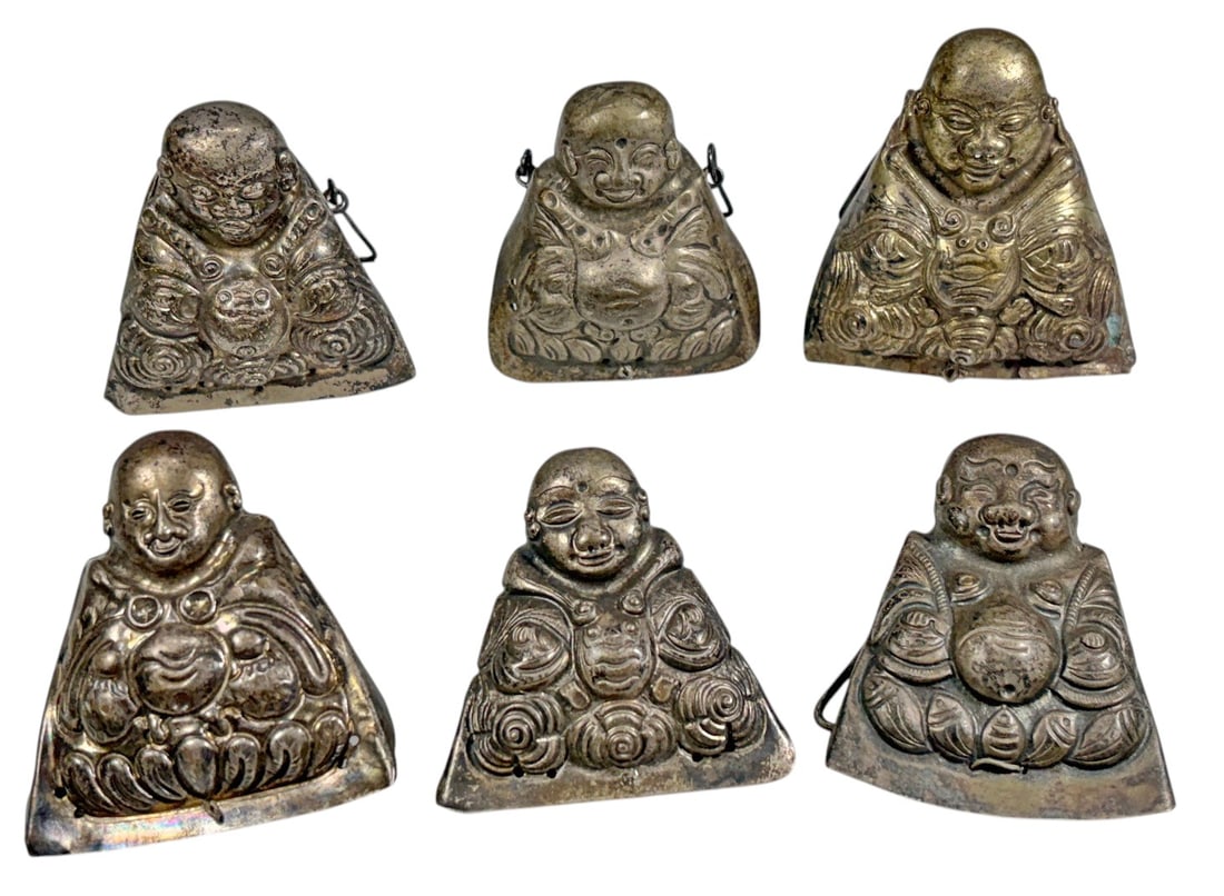 Chinese Silver Figural Monk Ornaments 6pc LOT: Set of six Chinese silver figural ornaments, each modeled as a seated smiling monk or auspicious figure with detailed robes, rounded facial features, and varied decorative attributes. Each piece has a