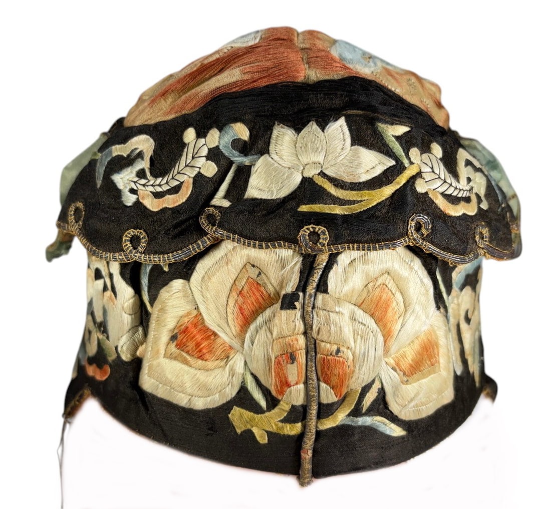 Chinese Embroidered Silk Ornate Official-Style Hat: Antique Chinese embroidered silk official-style hat featuring a black silk body with elaborate floral, butterfly, and stylized decorative motifs worked in cream, blue, green, gold, and orange