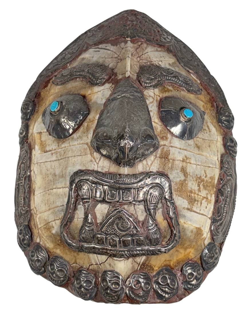 Tibetan Silver Turquoise Mask w/ Mottled Detail: Tibetan-style ritual mask or decorative plaque, with applied silver facial features and decorative mounts. The eyes are set with turquoise cabochons, and the lower edge is ornamented with a row of