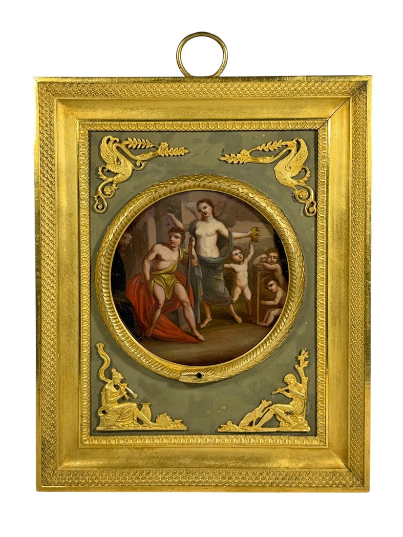 Neoclassical Gilt Bronze Mythological Plaque 7.75": Decorative neoclassical-style framed plaque featuring a circular painted miniature with mythological figures and putti, set within a raised gilt surround. The composition is mounted against a muted