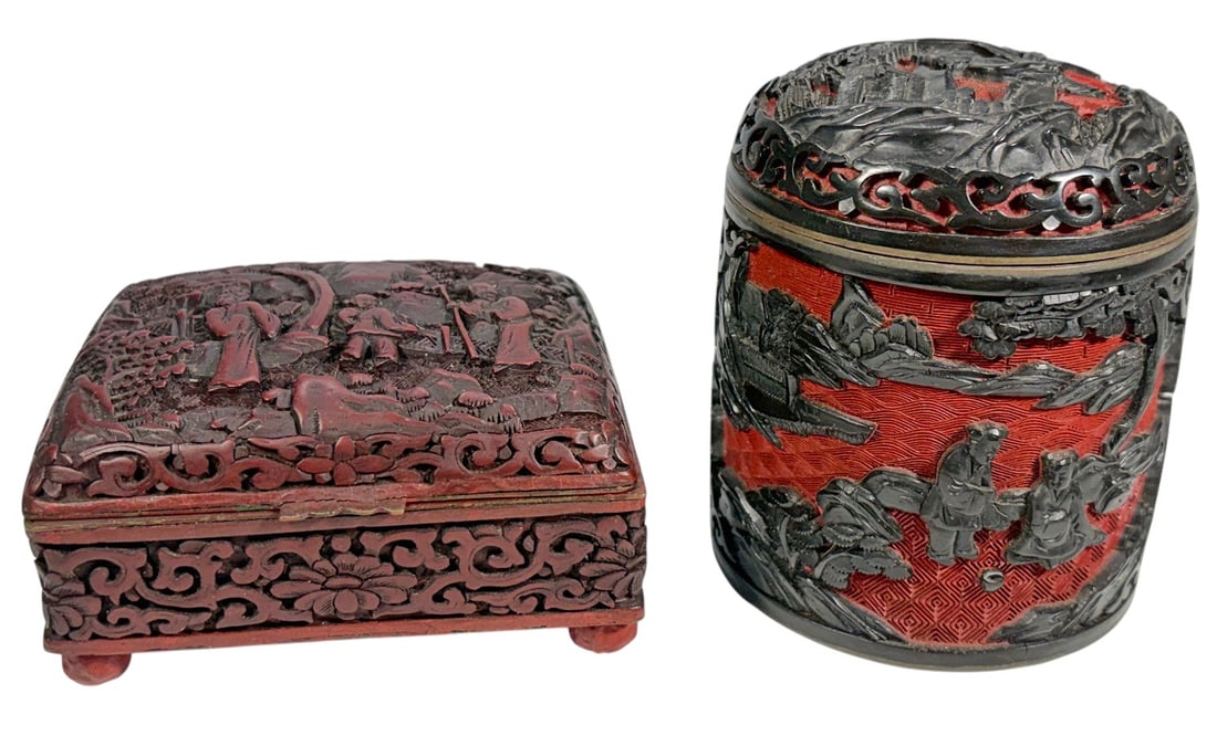 Chinese Carved Cinnabar Style Relief Boxes 2pc LOT: Two Chinese decorative boxes with red grounds and dark raised carved-style decoration. The lot includes one cylindrical lidded box with elaborate floral and figural motifs and a bright blue enameled