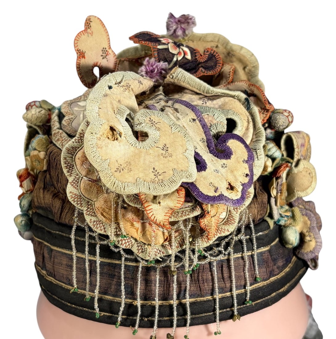 Chinese Embroidered Silk Ceremonial Headpiece: Traditional Chinese silk ceremonial headpiece richly decorated with embroidered birds, flowers, butterflies, applique ornaments, padded elements, and hanging tassels. Likely late Qing to early 20th