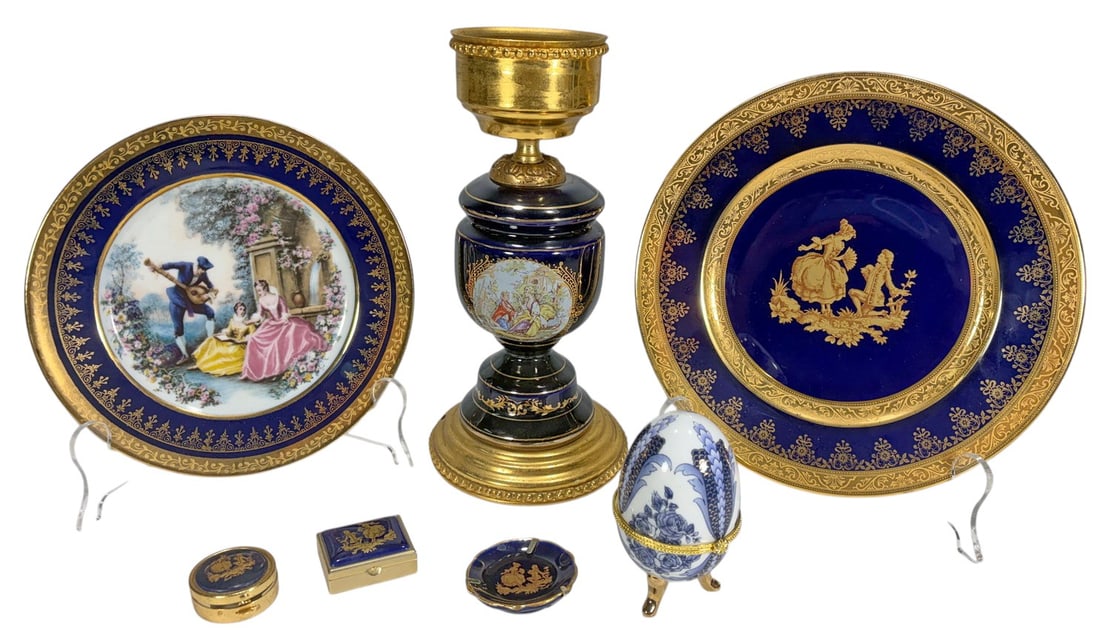 Limoges France & Other Gilt Fine Porcelain 7pc LOT: Seven-piece decorative porcelain group featuring cobalt-blue grounds with gilt and figural decoration. The lot includes one Limoges-style lamp base with gilt-metal mounts and a hand-painted romantic s
