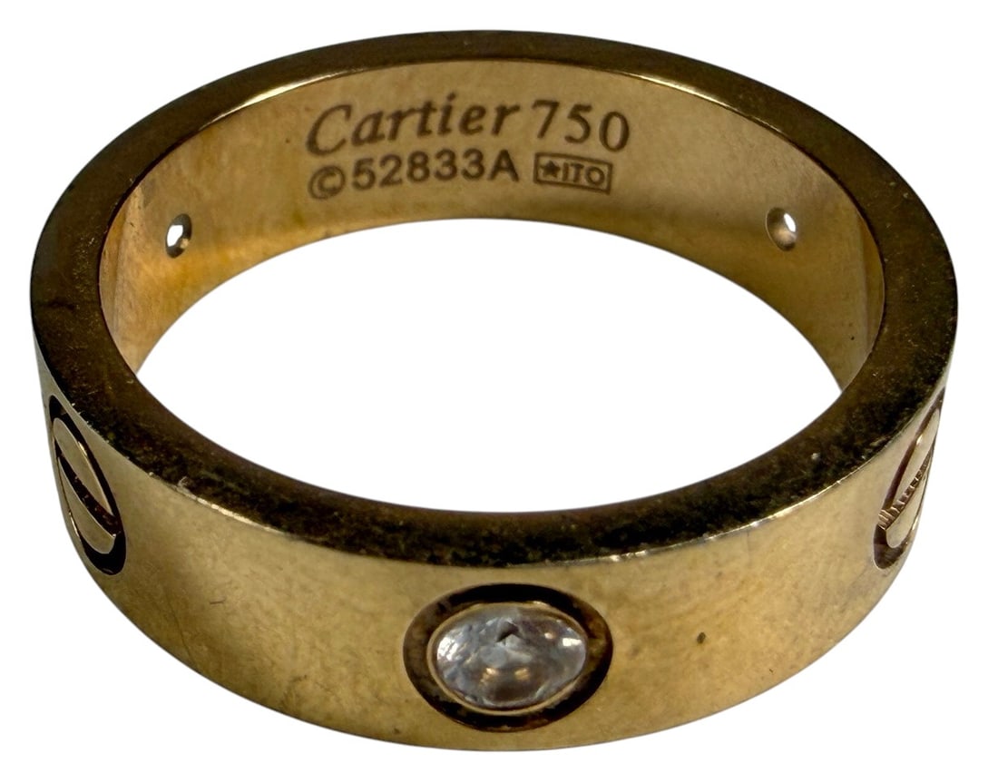 Inspired Design Gold-Plated Love Band Ring w Stone: Gold-plated ring featuring screw-motif decoration and a bezel-set clear stone. The interior bears markings, and additional engraved numbers. Approximate ring size 10. Condition: Good overall condition