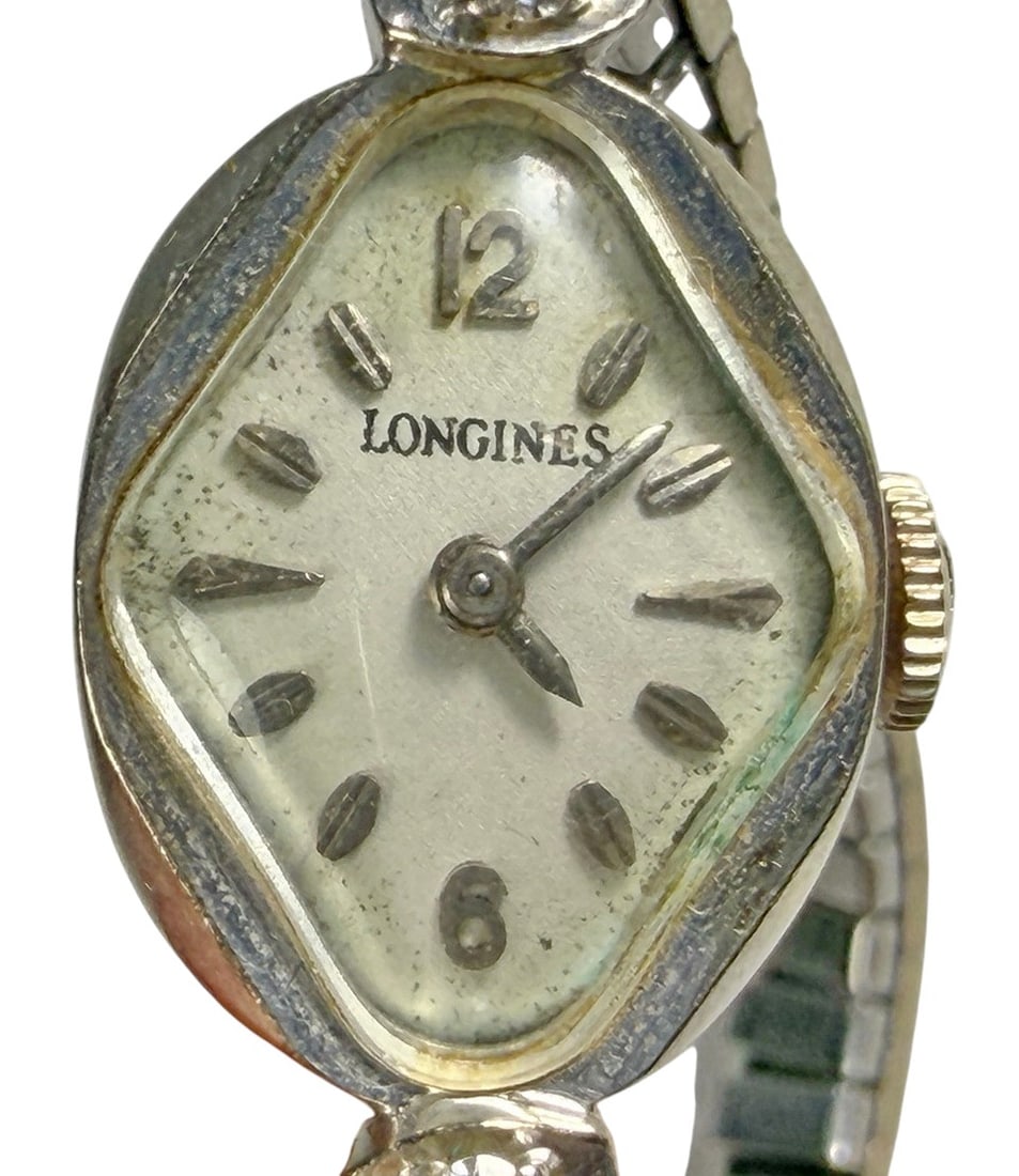 Longines 14K Gold Ladies Watch with Speidel Band: Vintage Longines ladies wristwatch featuring an asymmetrical cushion-shaped 14K gold case measuring approximately 1.25 x 0.5 inches, silver-tone dial, applied gold-tone hour markers, and Arabic numera