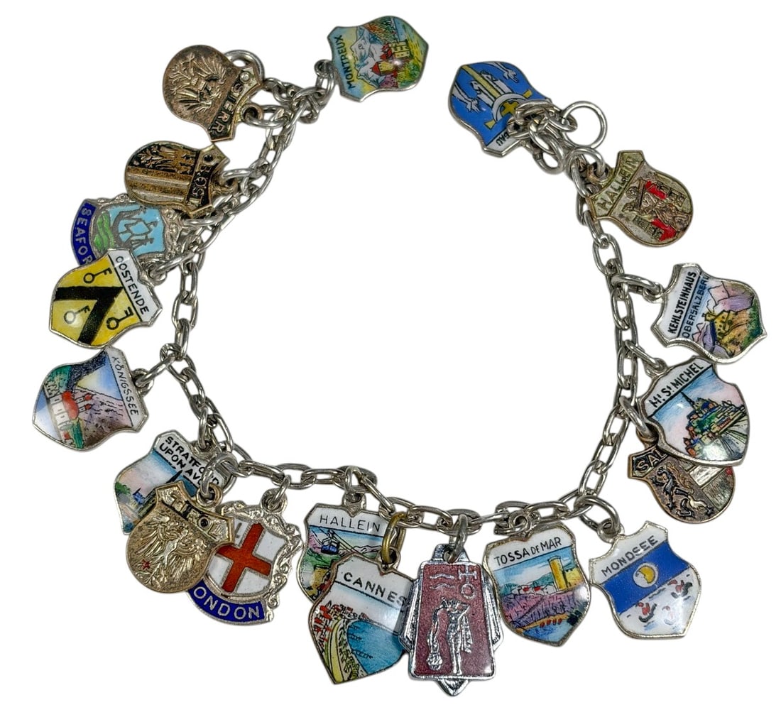 Silver European Enamel Travel Charm Bracelet: Vintage silver European souvenir charm bracelet featuring a link chain fitted with numerous colorful enamel travel and heraldic shield charms. Designs include London and other European city, regional,
