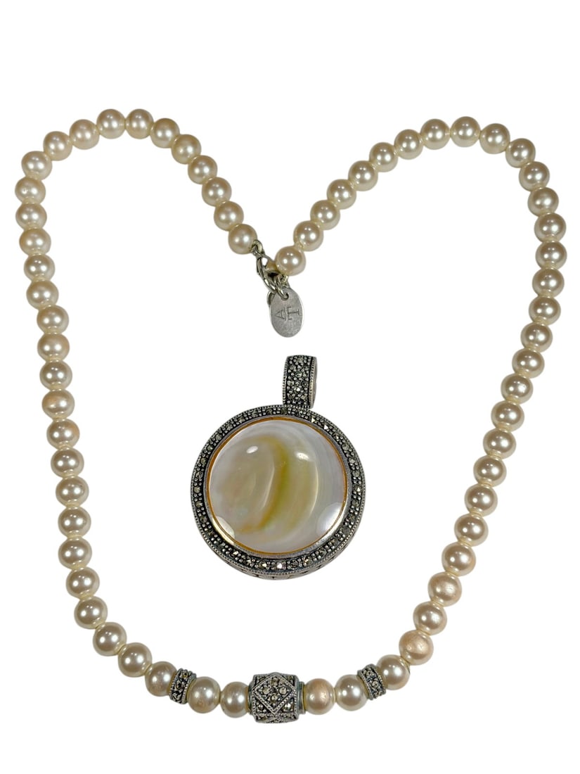 Sterling Silver Pearl & Mother-of-Pearl Necklace: Elegant necklace composed of cream-colored pearl beads accented with sterling silver and marcasite-style spacer elements. The focal point is a large round mother-of-pearl cabochon pendant set in an or