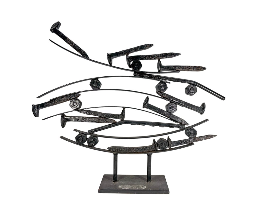 TransForm Brutalist Iron Aircraft Sculpture 20": Brutalist-style welded iron sculpture depicting a dynamic formation of stylized aircraft in flight, mounted on a rectangular metal base. Applied plaque to base inscribed TRANSFORM with artist or maker