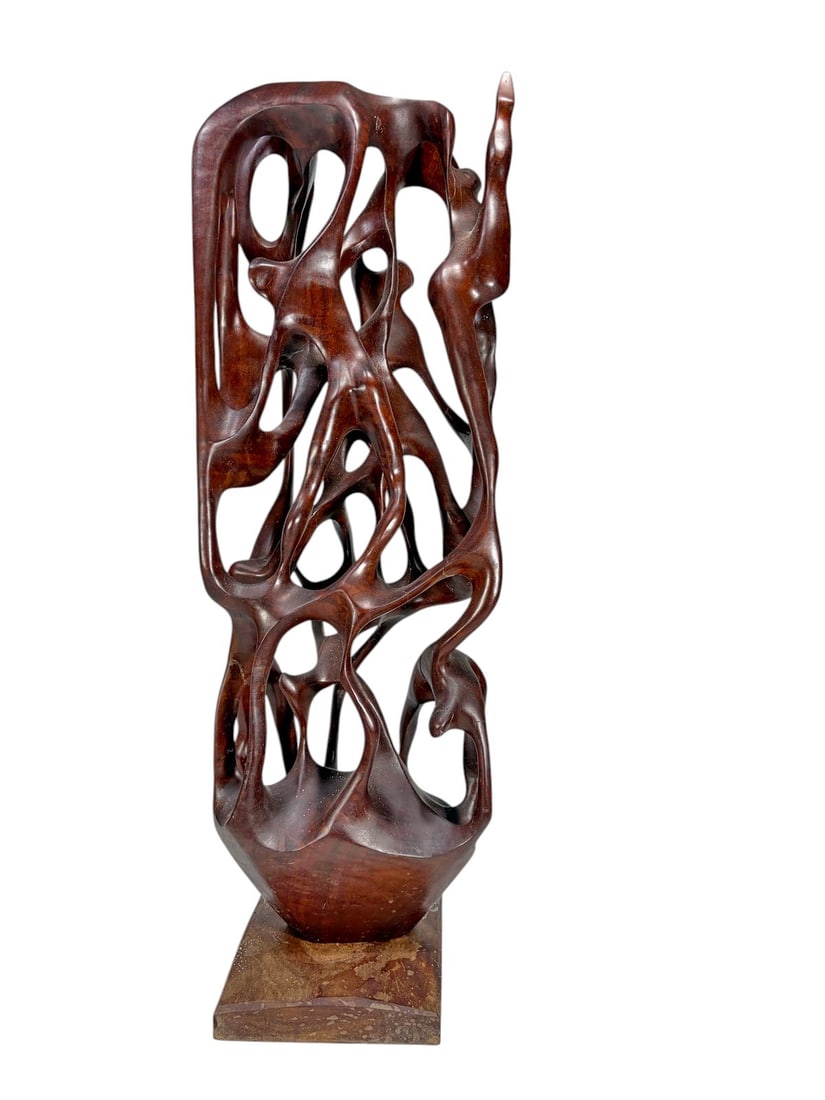 Hand Carved Biomorphic Abstract Wood Sculpture: Hand carved and polished wooden abstract sculpture of tall vertical form, featuring an intricate biomorphic composition of flowing interconnected openwork elements. Mounted on a rectangular wood base.