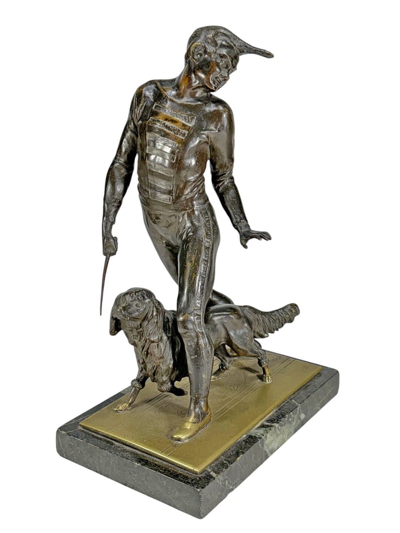 Art Deco Performer & Spaniel Dog Bronze Sculpture: Art Deco bronze sculpture of a male performer with a spaniel, in geometric costume on veined marble base, depicting a dynamic pose with outstretched baton. Dimensions: 12.75 X 8.75 X 5.5 in. Condition