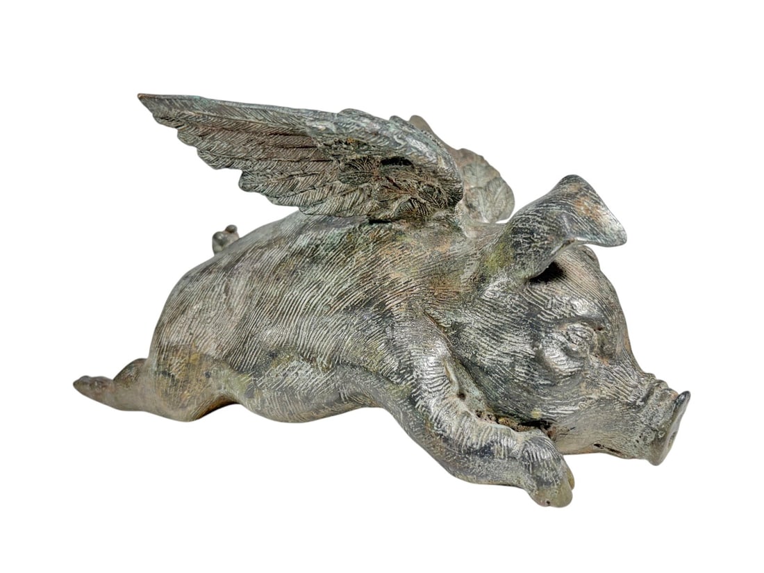 Chiseled Patinated Bronze Winged Pig Sculpture: Chiseled patinated bronze figurine depicting a reclining winged pig, finely modeled with textured surface details, raised feathered wings and naturalistic features. Condition: Good overall condition h