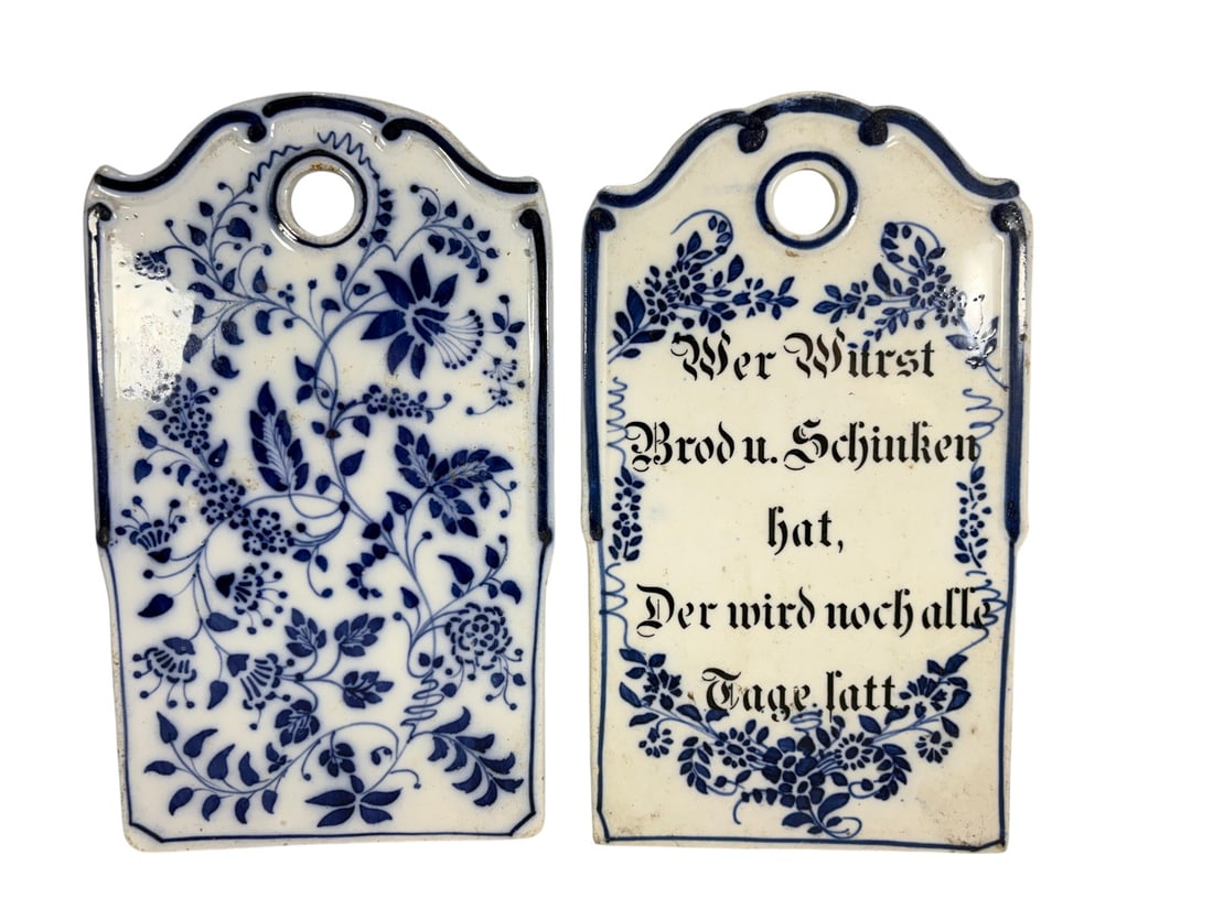 Adolf Heckmann Annaburg Blue Porcelain Plaques 2pc: A pair of German Blue Onion porcelain plaques attributed to Adolf Heckmann of Annaburg, as indicated by the accompanying handwritten inventory tag. Each plaque is decorated in the traditional blue-and