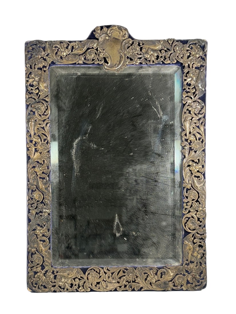 English Silver Rococo Vanity Dressing Table Mirror: Antique English silver dressing table mirror featuring an elaborate pierced and repousse Rococo-style frame with scrolling foliage, flowers, shells, and figural decorative elements. The rectangular