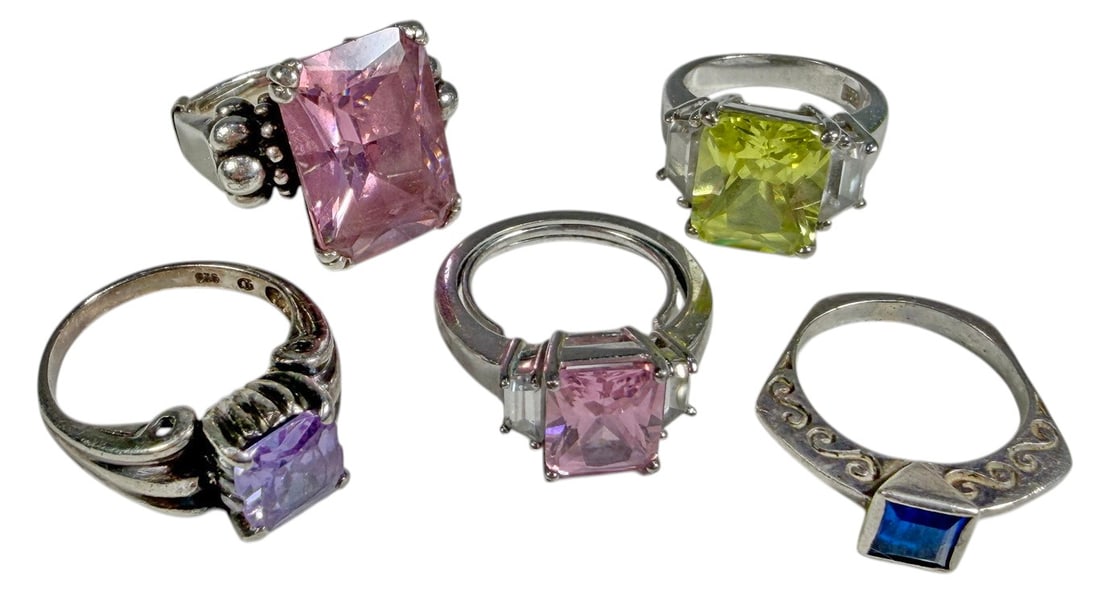 Assorted 925 Sterling Silver Gemstone Rings 5pcs: A lot of five sterling silver rings featuring colorful faceted stones in assorted designs. The group includes rings set with pink, purple, blue, and yellow-green stones, including rectangular, square,