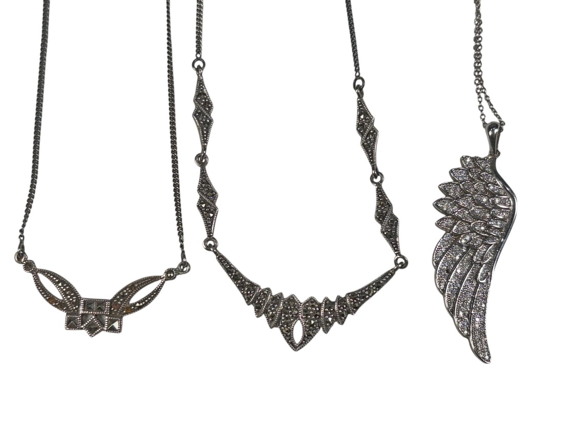 925 Sterling Silver Marcasite Necklaces 3pc LOT: A lot of three decorative sterling silver necklaces in assorted designs. The group includes one ornate geometric necklace with marcasite-style accents, one necklace featuring a large wing-shaped