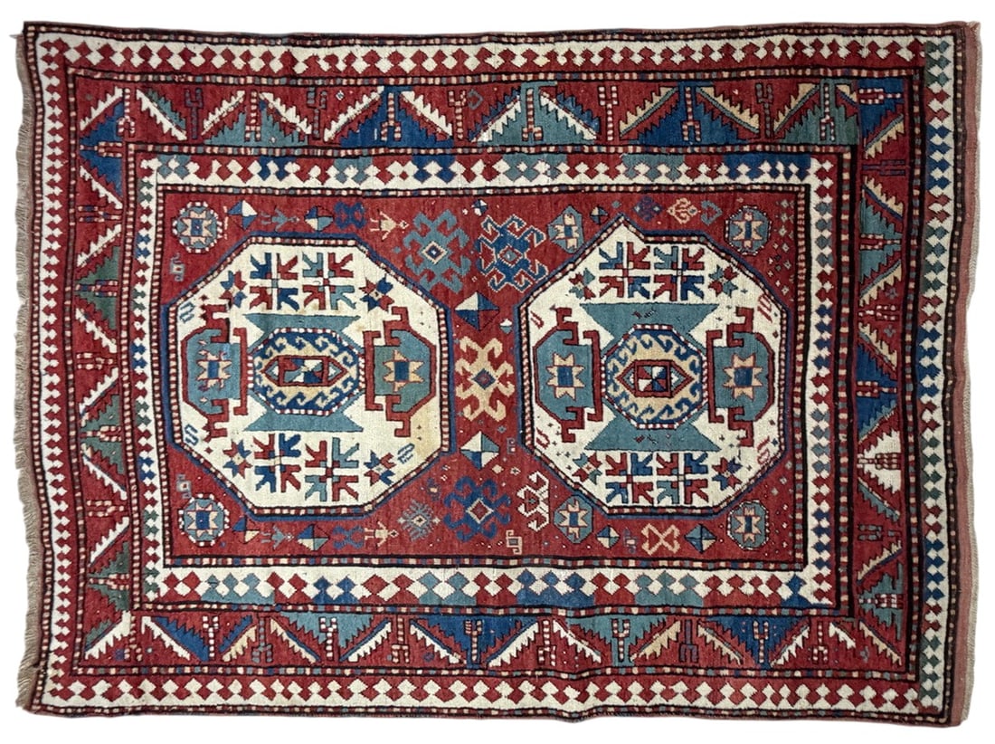 Lori Pambak Kazak Geometric Tribal Wool Area Rug: Traditional Lori Pambak Kazak-style wool rug featuring two large octagonal medallions on a rich red field. The design is filled with bold geometric and tribal motifs in cream, pale blue, cobalt blue, 
