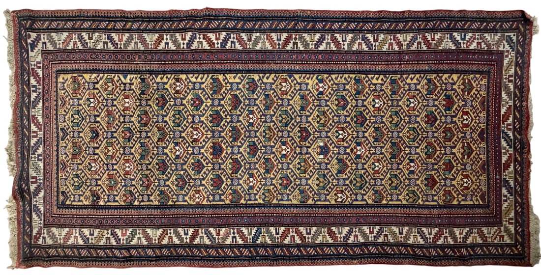 Antique Caucasian Hand-Knotted Wool Runner 1900: Antique Caucasian wool runner, circa 1900, featuring a traditional hand-knotted construction and a geometric pattern in warm golden apricot, cream, muted red, and complementary earth tones. The elonga