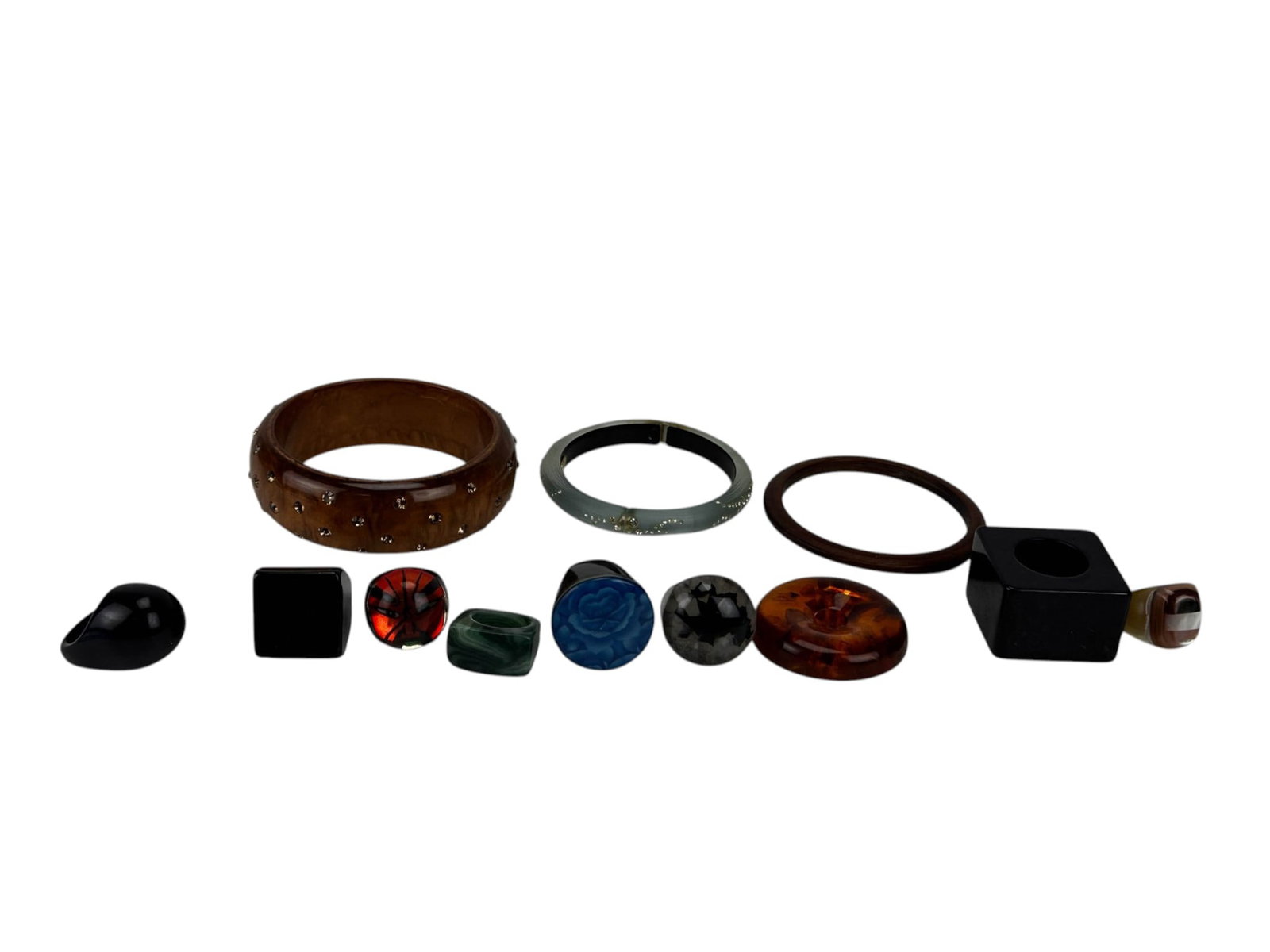Lucite Resin Rings Rhinestone Bangle Jewelry LOIT: Group of vintage and contemporary costume jewelry comprising assorted lucite, resin, and plastic rings, wood and acrylic bangles, and a pendant. Includes oversized geometric and domed rings in black, 