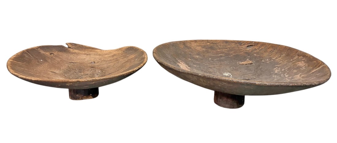 Old Berber Carved Acacia Wood Tazzas 2pc LOT: Pair of old Berber hand-carved acacia wood tazzas or couscous serving bowls, each raised on a short pedestal foot. Both pieces feature broad, shallow forms with pronounced hand-worked surfaces, warm b