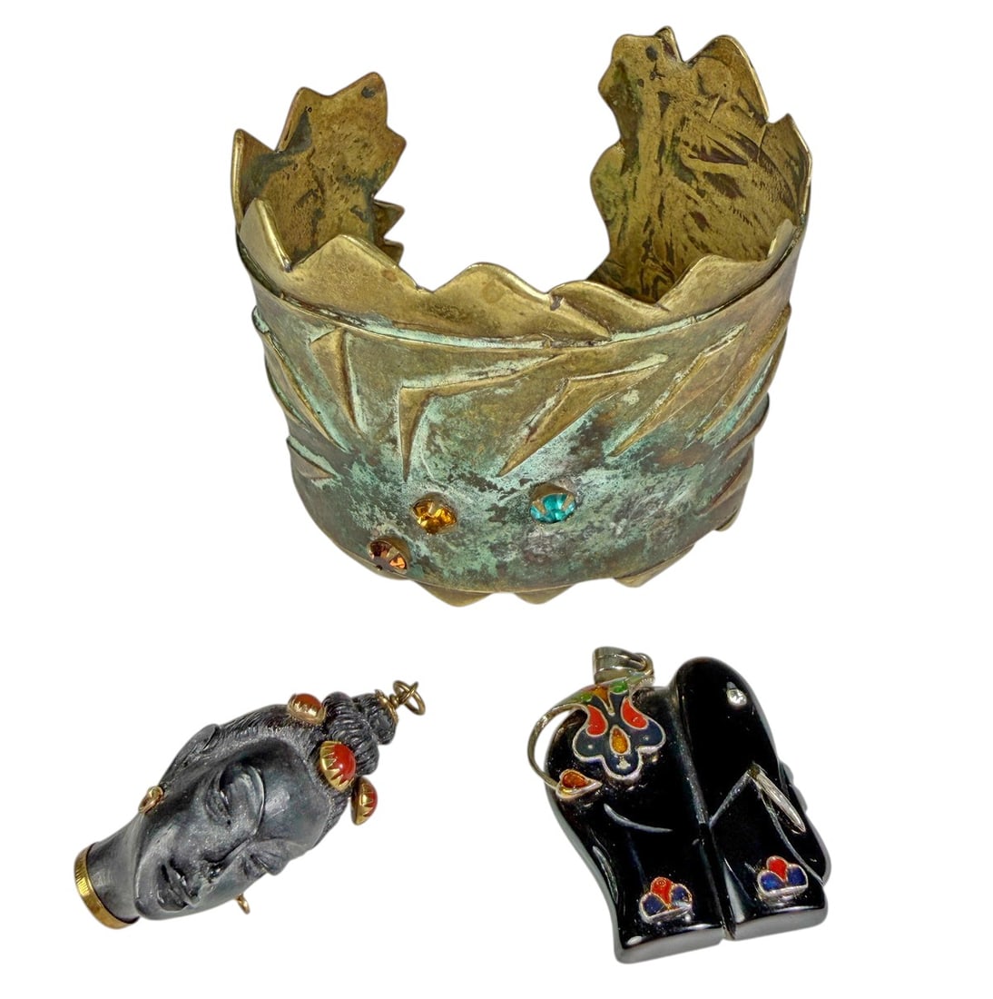 10K Gold Corletto Ebony Head & Cuff 3pc LOT: A distinctive three-piece jewelry lot featuring a sculptural Brutalist / Modernist bronze cuff bracelet together with two smaller figural pendants. The wide cuff has layered geometric metalwork, prono