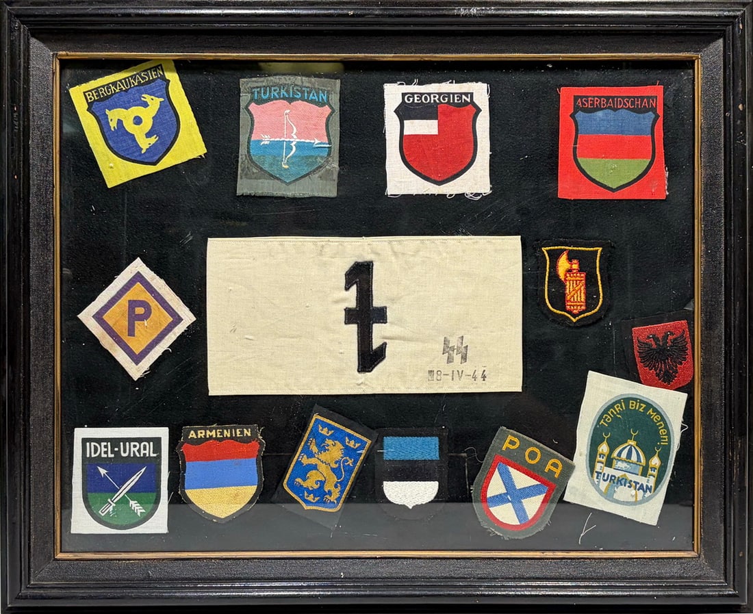 WWII SS European Military Patch Display, Framed: Framed collection of assorted WWII-era European military and regional cloth insignia and patches, including examples marked Bergkaukasien, Turkistan, Georgien, Aserbaidschan, Idel-Ural, and Armenien. 