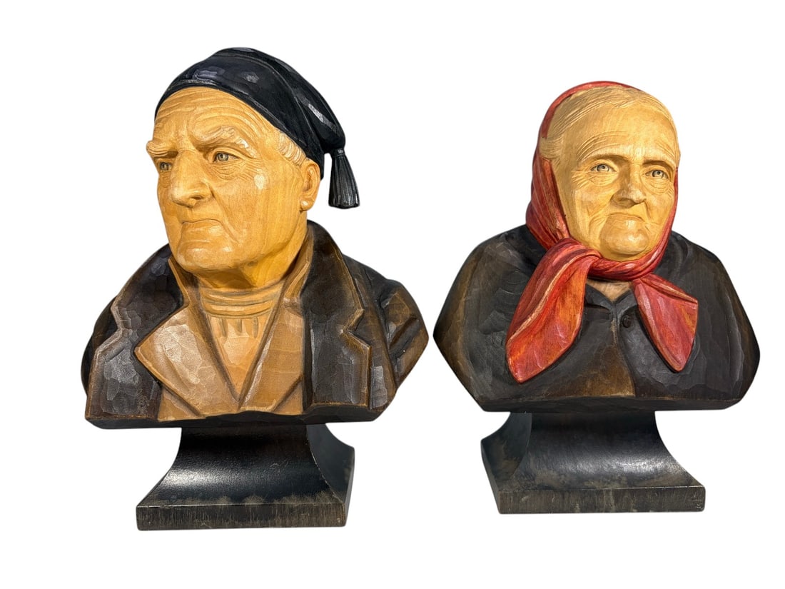 Swiss Huggler Wyss Carved Wood Busts 2pc LOT: Two-piece LOT of Swiss carved and hand-painted wood portrait busts depicting an elderly woman wearing a red headscarf and an elderly man wearing a black cap. Carved with detailed facial features and