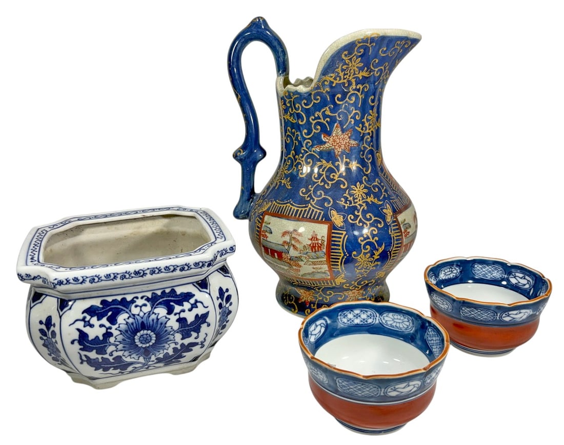 Asian Blue & White Gilt Porcelain Group 4pc LOT: Four-piece group of Asian porcelain comprising a large blue-ground pitcher with gilt decoration and painted landscape reserves, a blue-and-white rectangular planter with floral decoration, and a pair