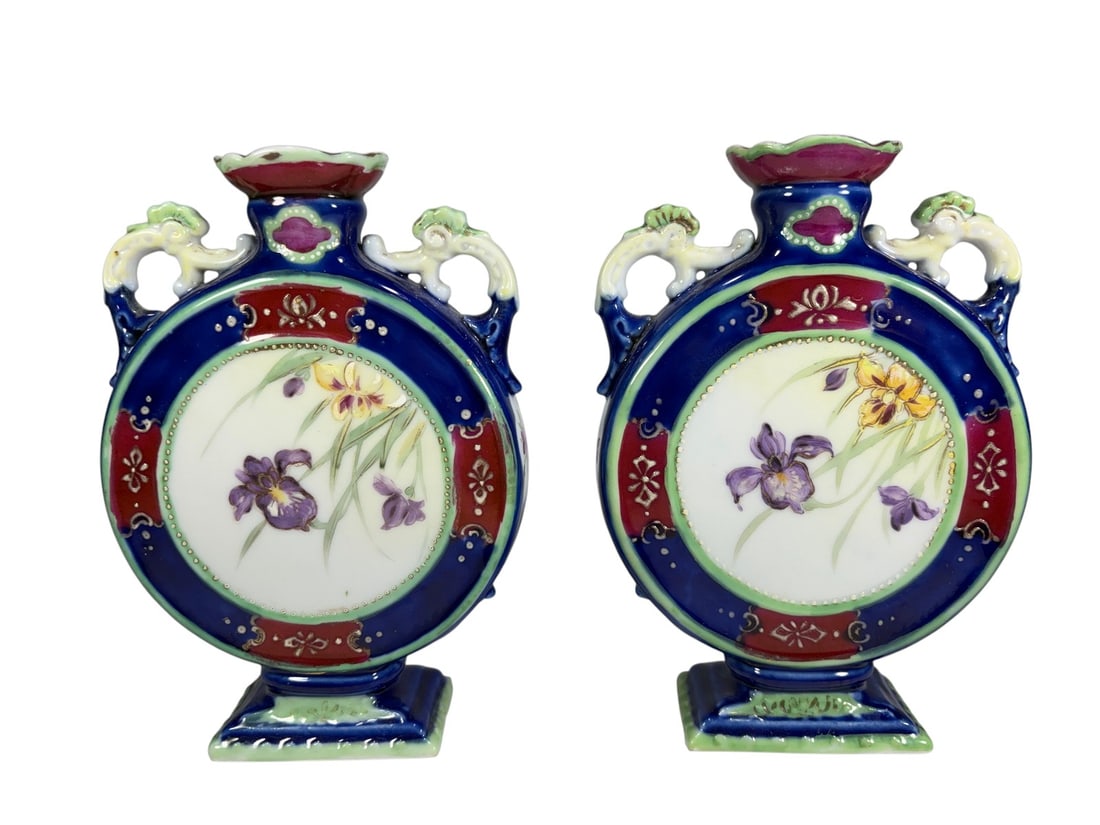 Pair of Japanese Imari Porcelain Moon Flasks: Pair of Japanese Imari porcelain moon flasks of flattened circular form, decorated in cobalt blue, iron red, pale green, and gilt accents. The central reserves are hand painted with flowering iris