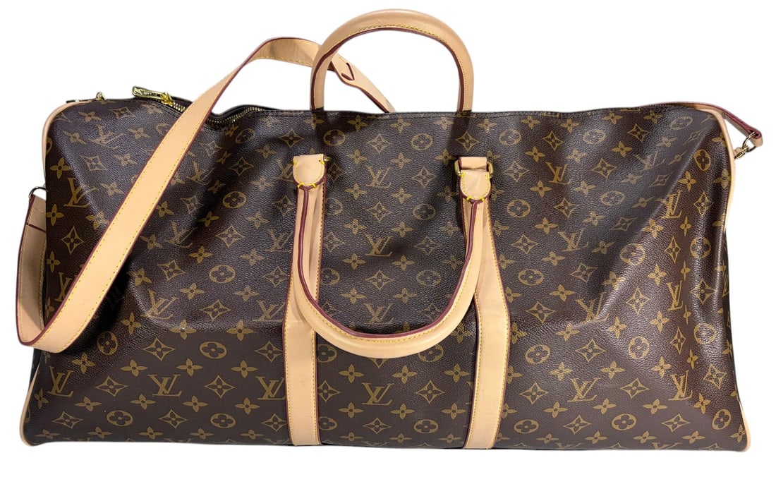 Famous Fashion Design Style Monogram Travel Bag: Famous Design Style Monogram Travel Bag with brown monogram coated canvas exterior and tan leather trim. Features dual rolled handles, detachable shoulder strap with gold tone hardware, zip top closur