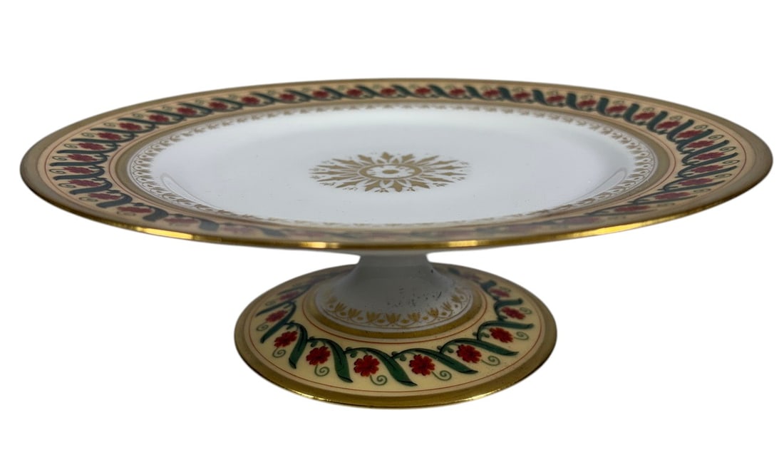 Tiffany & Co Sevres Camille Le Tallec Cake Stand: A porcelain cake stand based on a design by Camille Le Tallec for Tiffany & Co., decorated with gilt and polychrome floral motifs. This example bears a Sevres mark to the underside. Condition: Good ov