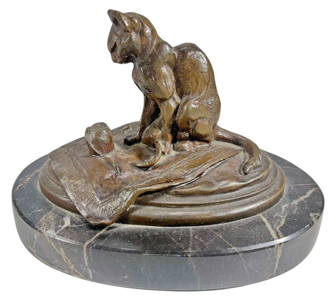 E. Fremiet French Bronze Cat Sculpture Signed: French bronze sculpture by Emmanuel Fremiet (18241910), depicting a seated cat on a tasseled cushion beside a small ball. Finely modeled with naturalistic details and a warm brown patina. Signed E. FR
