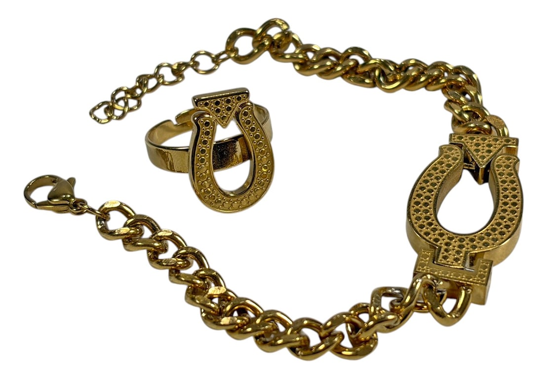 Gold-Tone Bracelet & Adjustable Ring 2pc LOT: Two-piece gold-tone metal jewelry lot including a curb-link bracelet with a large horseshoe-style centerpiece and a coordinating adjustable ring with a matching horseshoe motif. Both pieces feature te
