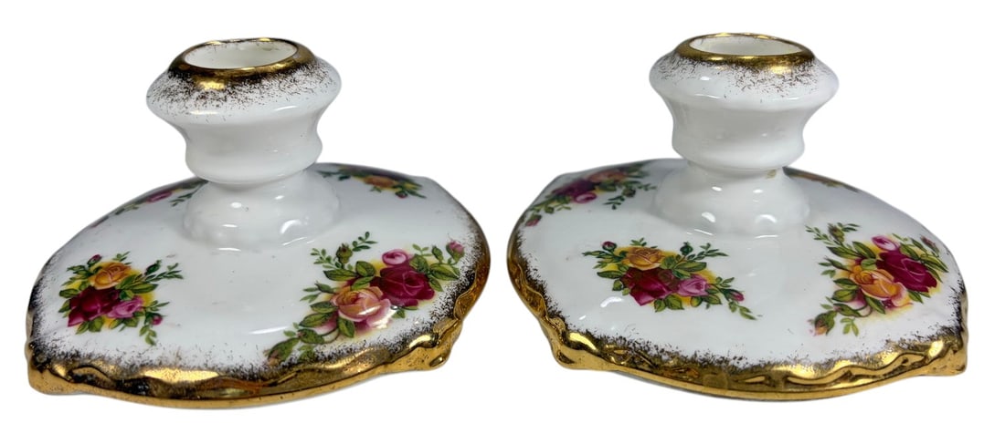 Royal Albert Old Country Roses Candlesticks 2pc LO: Pair of Royal Albert bone china candlesticks in the Old Country Roses pattern, decorated with red, pink, and yellow rose bouquets with green foliage and gilt accents along the scalloped bases and