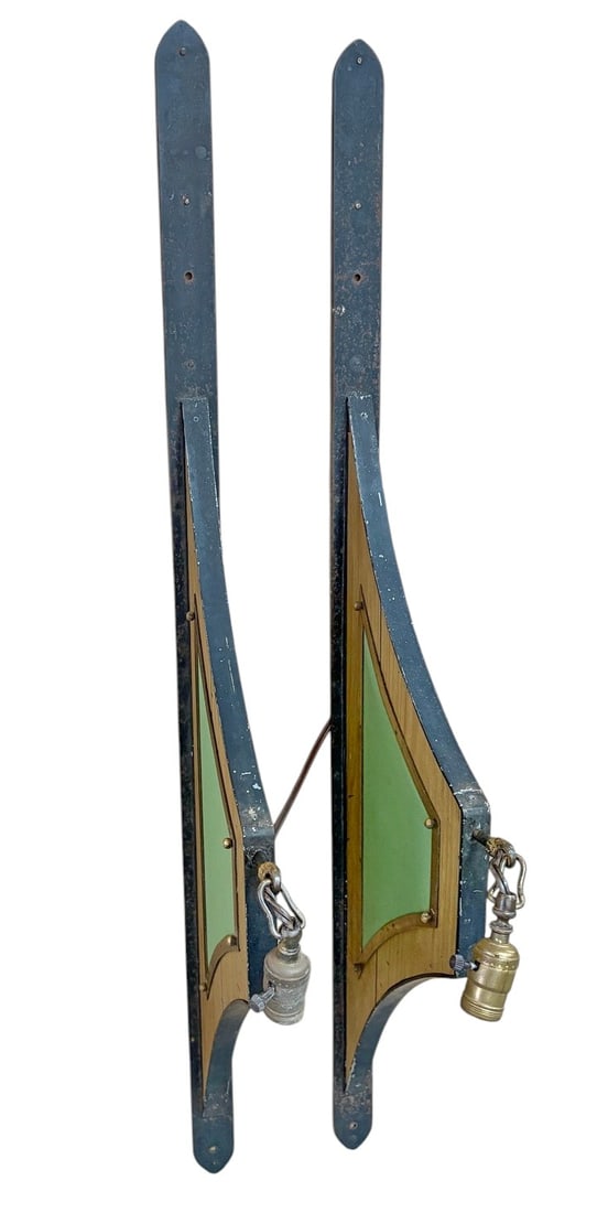 Iron Wood Brass Wall Sconces 2pc LOT: Pair of decorative wall sconces constructed of iron and wood with brass details. Each features an elongated sculptural form with curved wood panels, dark iron edging, green inset decoration, and artic