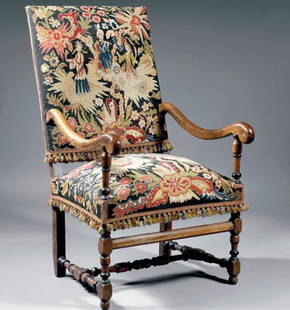 A Fine French Armchair: Louis XIV style armchair. Walnut with tapestry decorated with flowers and characters. Height: 3 3/8 feet- Width: 2 1/3 feet Depth: 1 2/3 feet