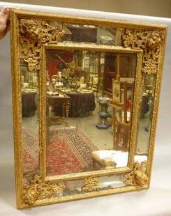 A Framed Mirror: Rectangular mirror with glazed beads in carved and gilded wood. 20th century. 40 inches x 33 inches