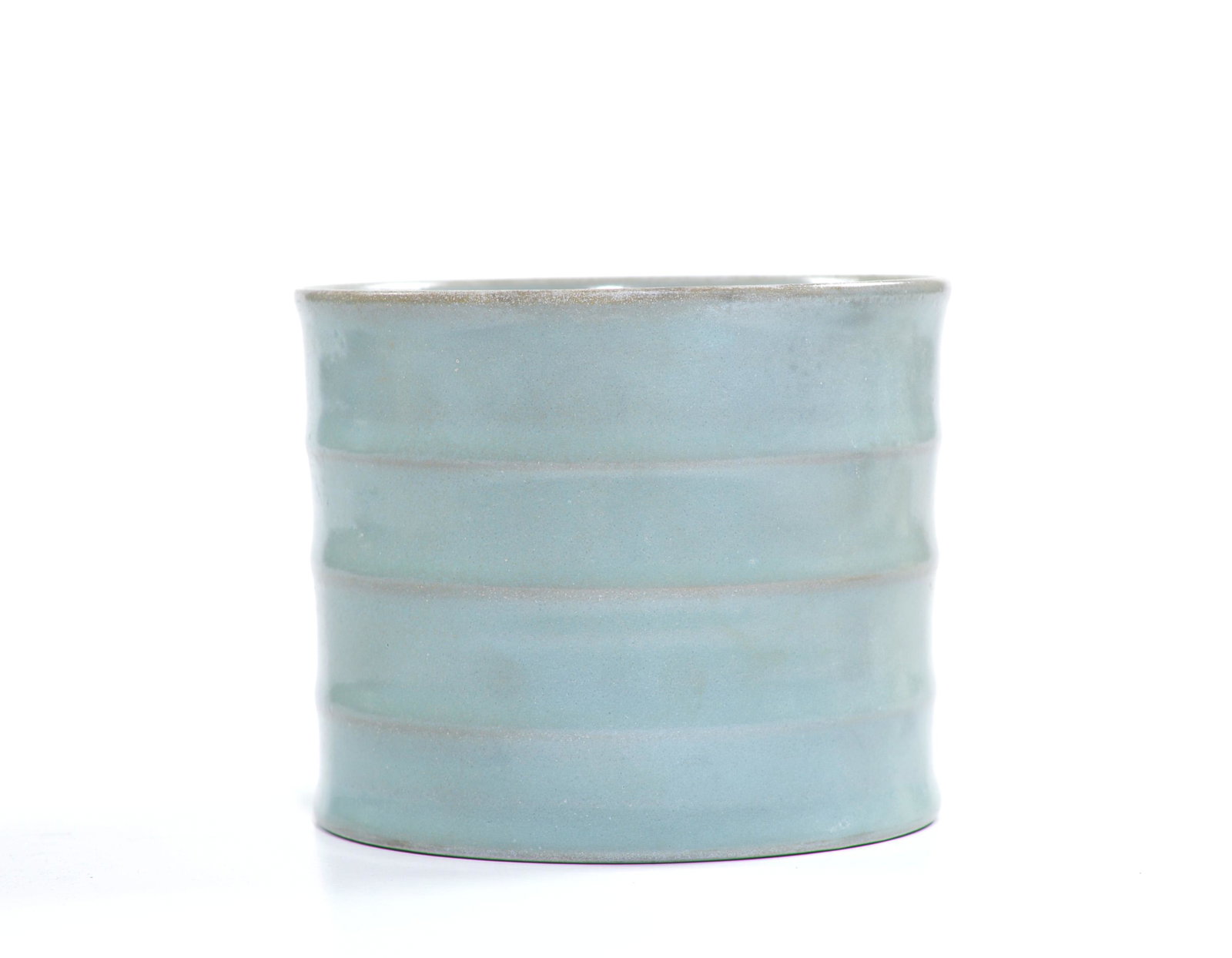 A Chinese "Ry-Type" Brush Pot: Cylindrical pot decorated with three fillets and covered overall in blueish-grey tone of glaze, light hairline cracks on the rim Ming dynasty D: 13CM, 5 1/4 INCHES