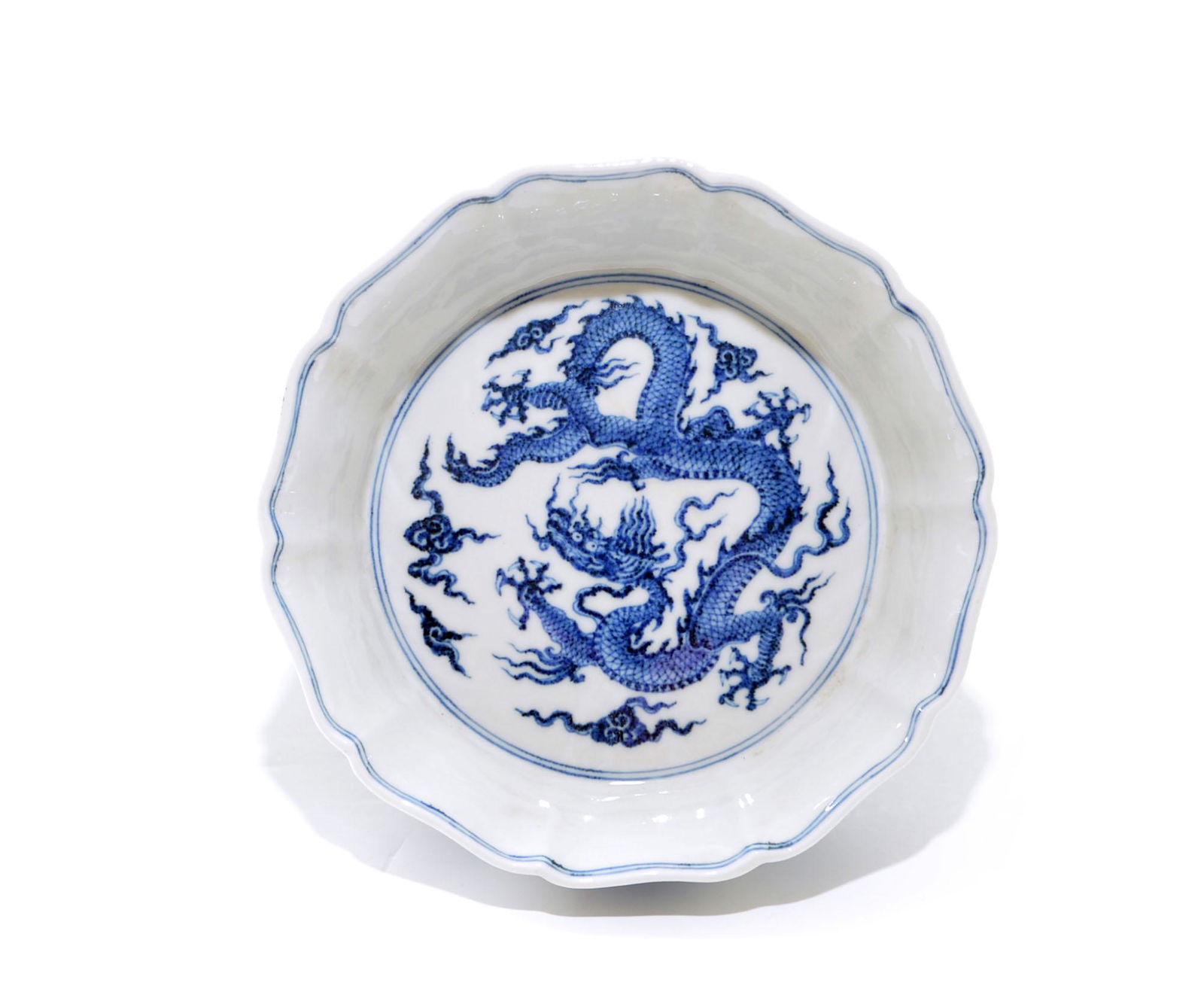 A Very Fine Chinese Blue and White 'Dragon' Dish: Lobed dish decorated with a ferocious dragon inside and on base, surrounded by ten dragon roundels on the exterior. D: 17 CM, 6 5/8 INCH