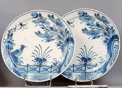 Pair of Enamel Plates: Pair of circular plates with blue monochrome decoration of a flowering hedge and a bird and insect in flight. 18th century. D: 22.6 cm.