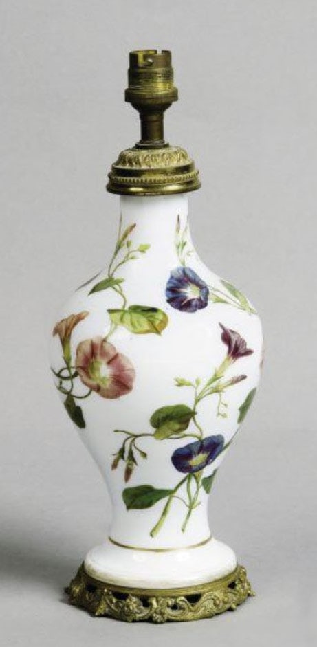 Glass Table Lamp: A baluster-shaped lamp in milky opal half-crystal decorated with polychrome morning glories, the mount in openwork gilt bronze.H: 23 cm