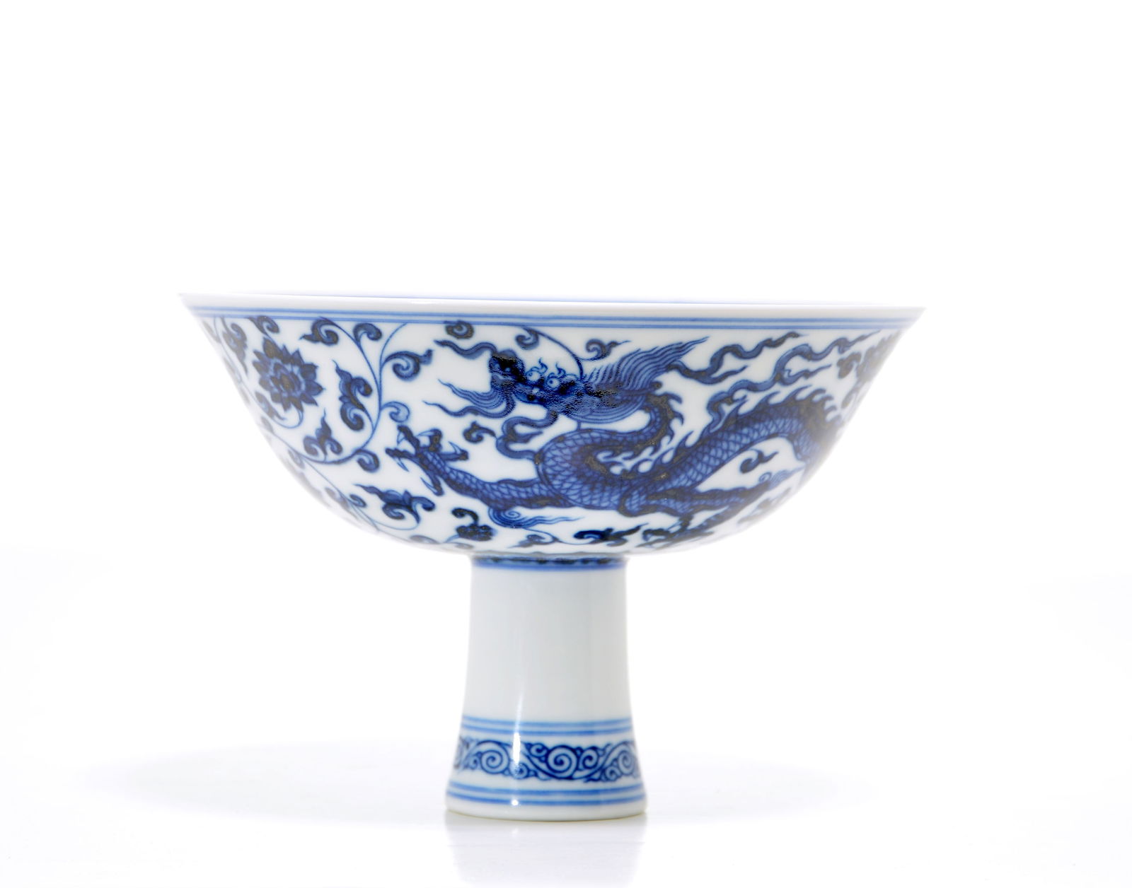 Rare Chinese Blue and White Stem Bowl: Elegant blue and white stem bowl features a flared rim and a tall, cylindrical foot decorated with a delicate scroll band. The exterior of the bowl is finely painted in vibrant cobalt tones with an im