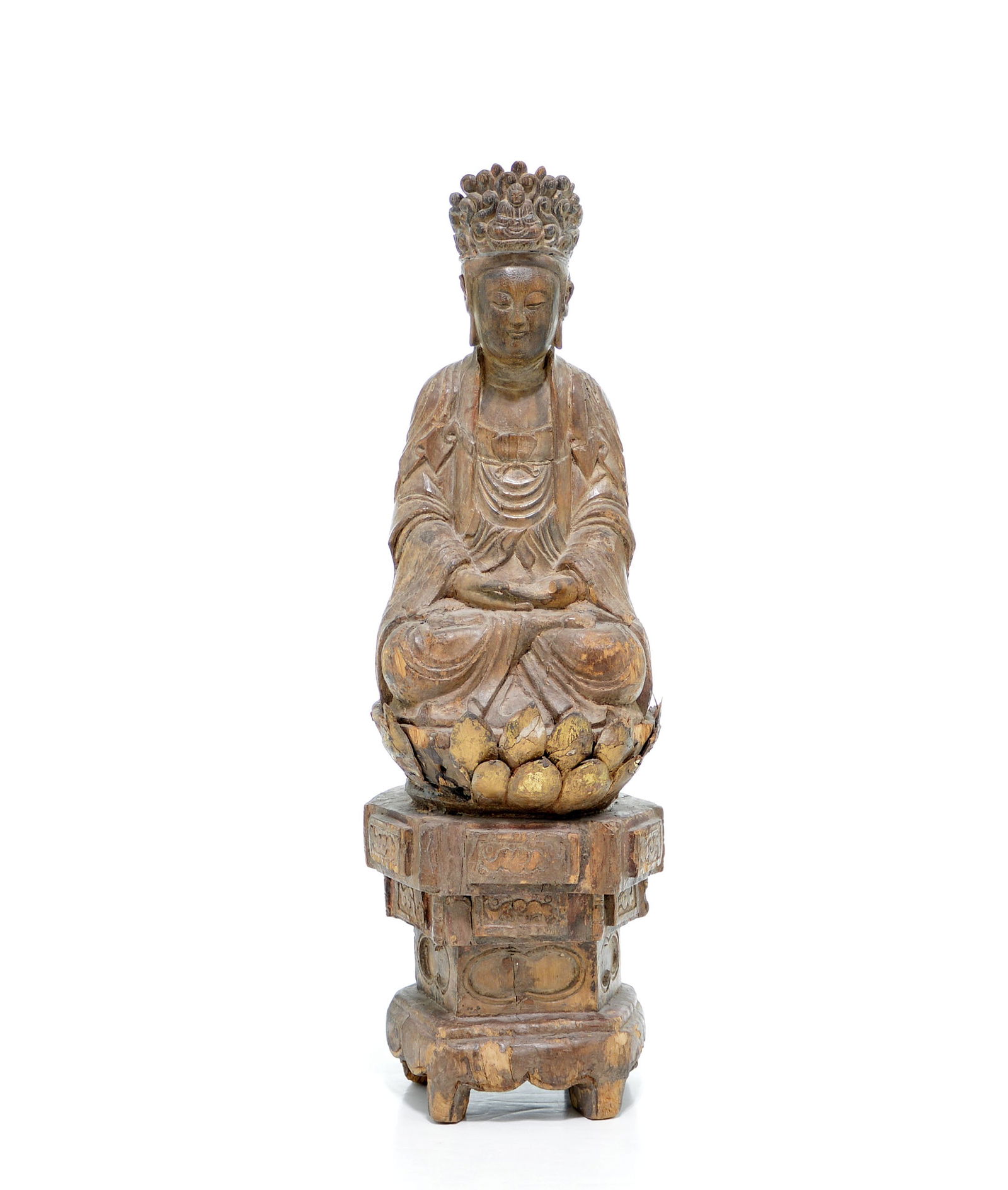 A Rare Carved Wood Figure of Seated Guanyin: The bodhisattva is depicted seated in dhyanasana (meditation posture) on a double-lotus throne, which is set upon a high, stepped hexagonal pedestal base. The figure's hands are clasped in a