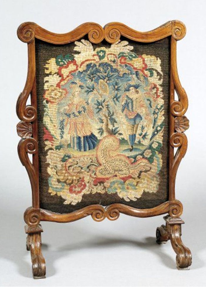 Rococo Style Needlepoint Fire Screen: Fireplace screen features a carved wooden frame with curved scroll elements and a needlepoint or tapestry panel. The central image shows two figures and a small animal in a garden setting. Four small